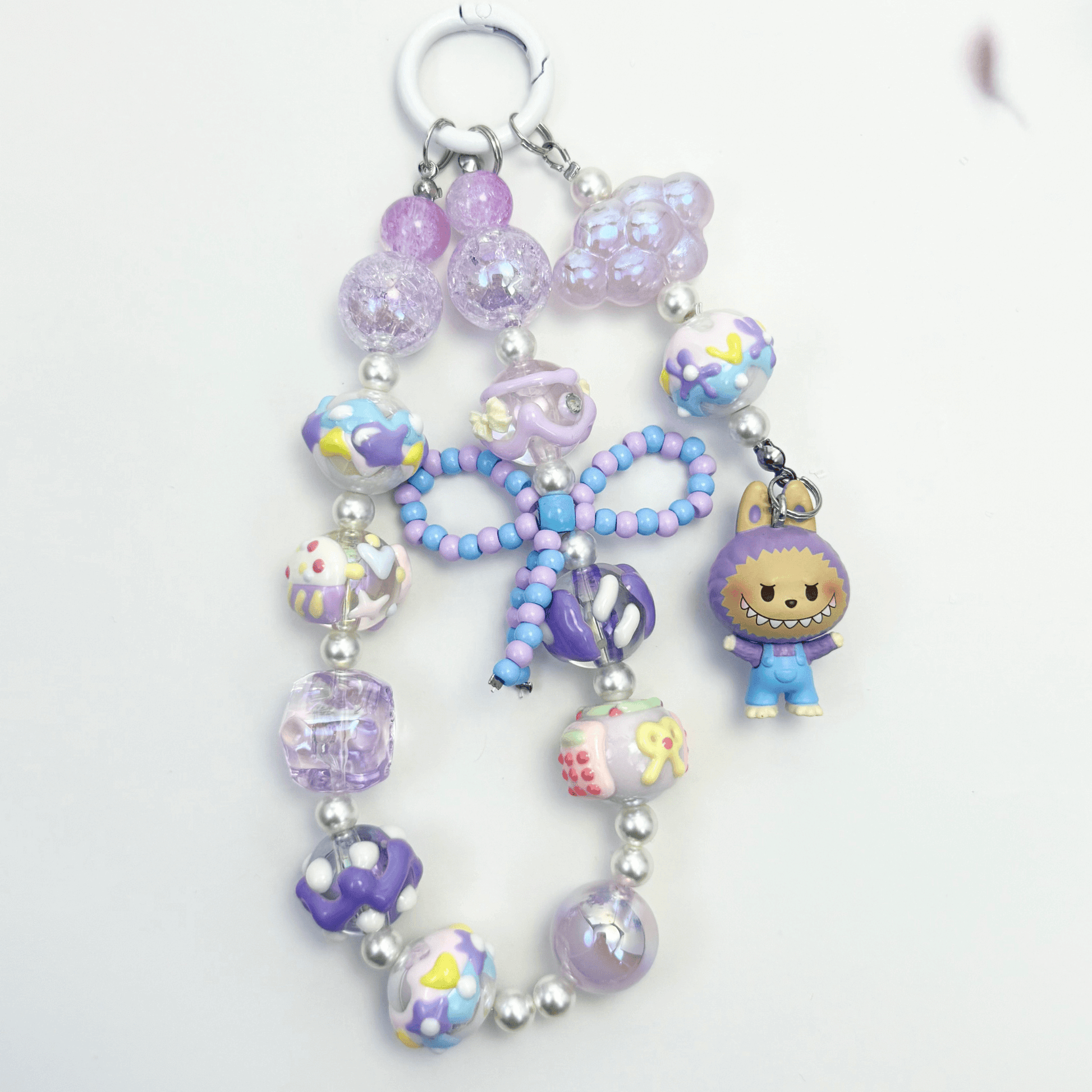 Handmade Labubu-inspired beaded keychains with pearls, glass beads, and colorful character charms – kawaii accessories in pastel and earth tones.