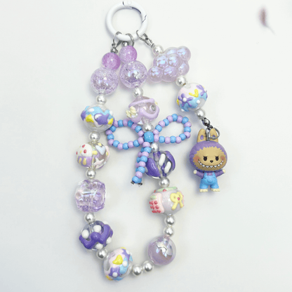 Handmade Labubu-inspired beaded keychains with pearls, glass beads, and colorful character charms – kawaii accessories in pastel and earth tones.