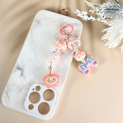 Pop Bean Labubu handmade phone charm in pink star theme, featuring kawaii beads, flowers, and a playful character, attached to a white marble phone case – cute accessory by MXW Jewellery