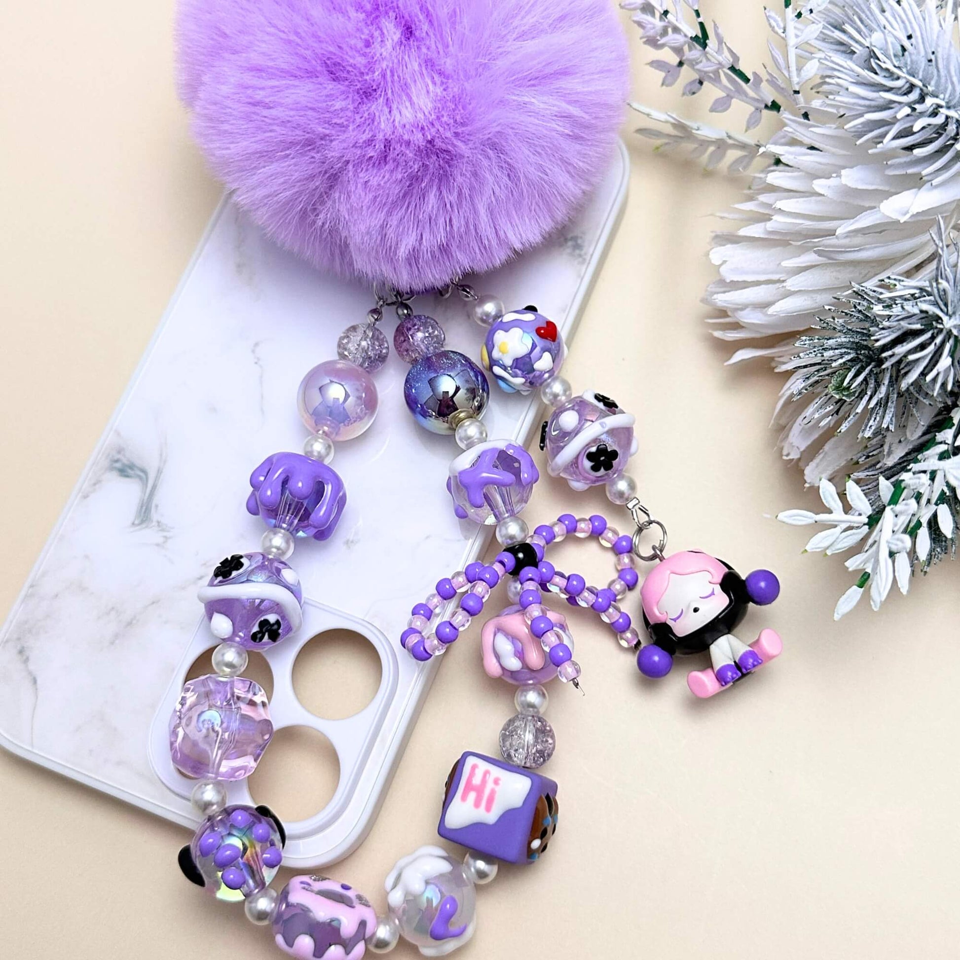 Handmade Pop Bean purple sitting sp phone charm with hand-painted polymer clay beads and faux pearls, attached to a keychain.