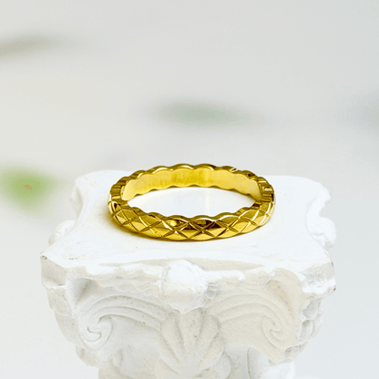 Slim quilted gold band ring with textured designer-inspired pattern.