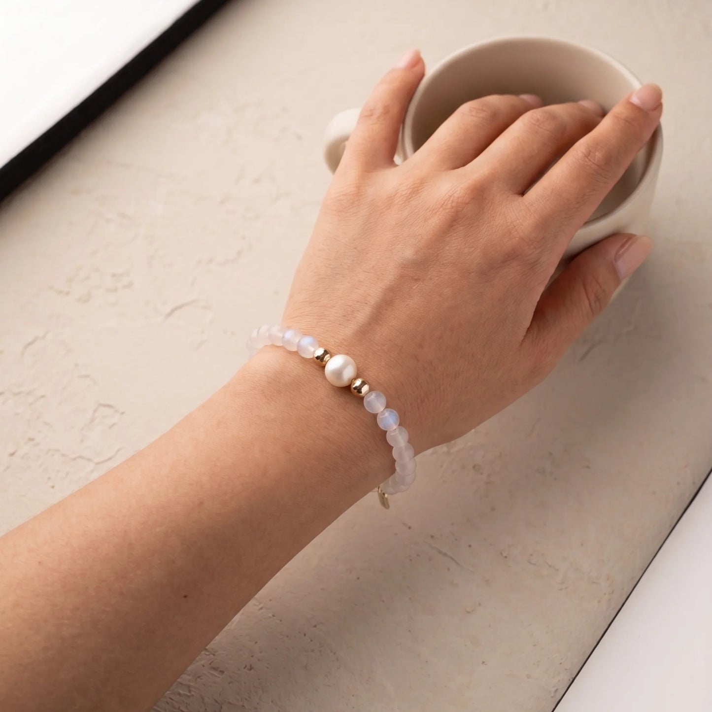 Rainbow moonstone, pearl and initial gold bracelet featuring luminous gemstone beads, lustrous freshwater pearls and a personalised gold-filled stamped initial disc.