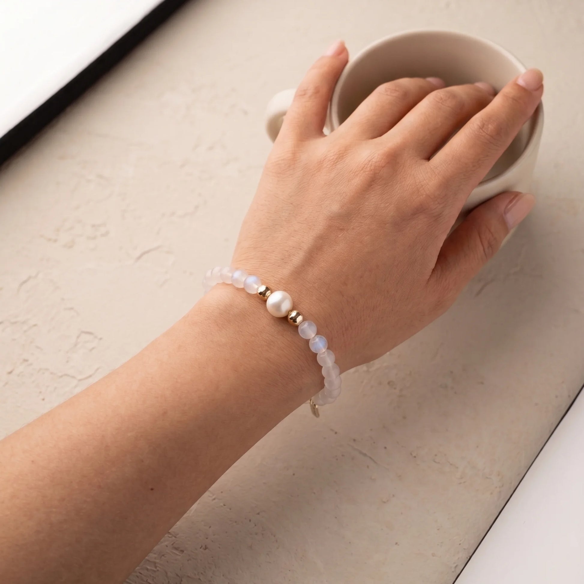Rainbow moonstone, pearl and initial gold bracelet featuring luminous gemstone beads, lustrous freshwater pearls and a personalised gold-filled stamped initial disc.