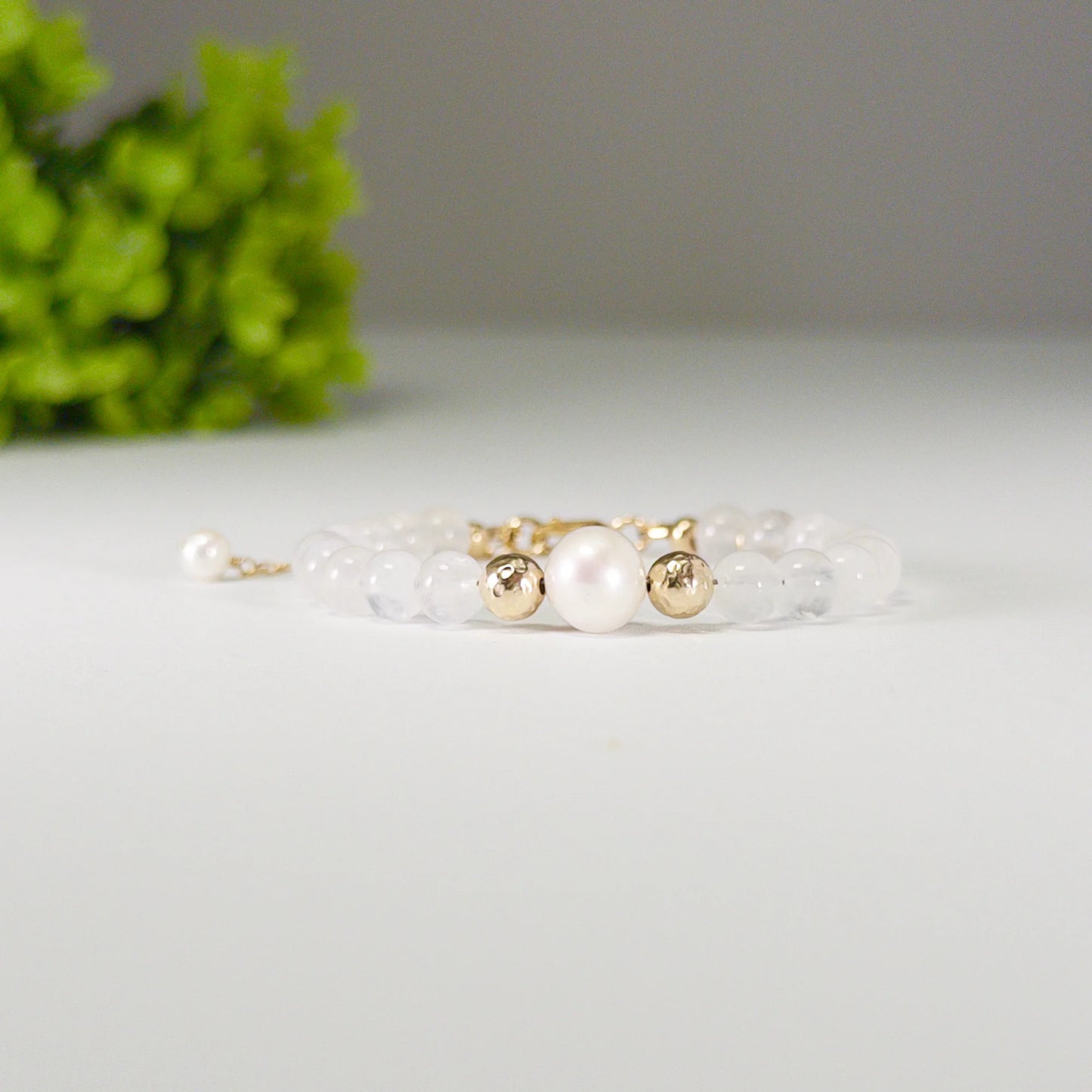 Rainbow moonstone, pearl and initial gold bracelet featuring luminous gemstone beads, lustrous freshwater pearls and a personalised gold-filled stamped initial disc.