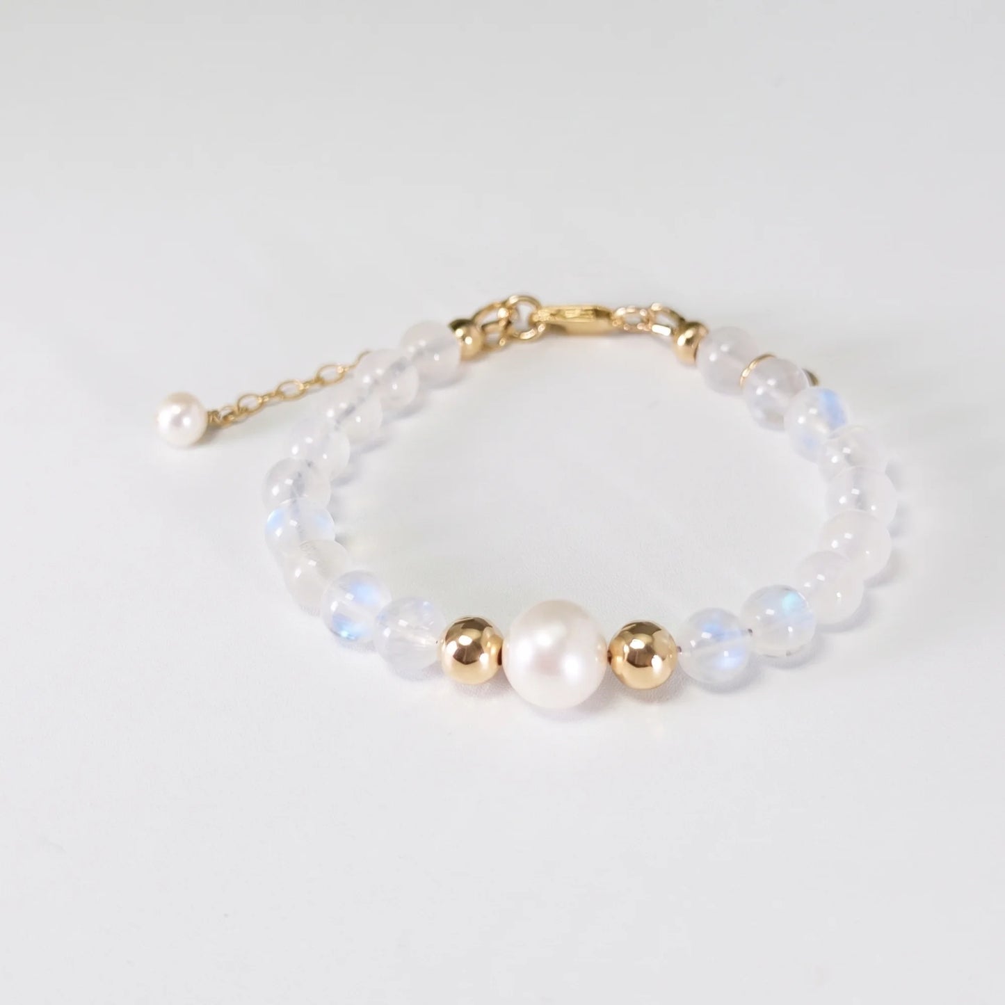 Rainbow moonstone, pearl and initial gold bracelet featuring luminous gemstone beads, lustrous freshwater pearls and a personalised gold-filled stamped initial disc.