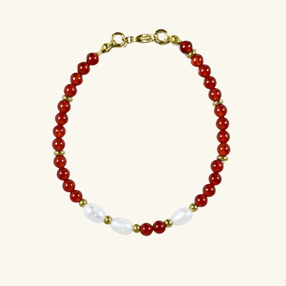 Handmade bracelet with red agate beads and freshwater pearl accents, finished with gold or silver findings.
