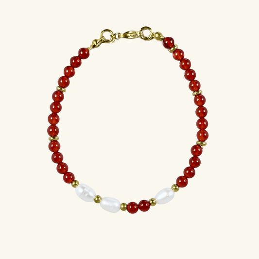 Handmade bracelet with red agate beads and freshwater pearl accents, finished with gold or silver findings.