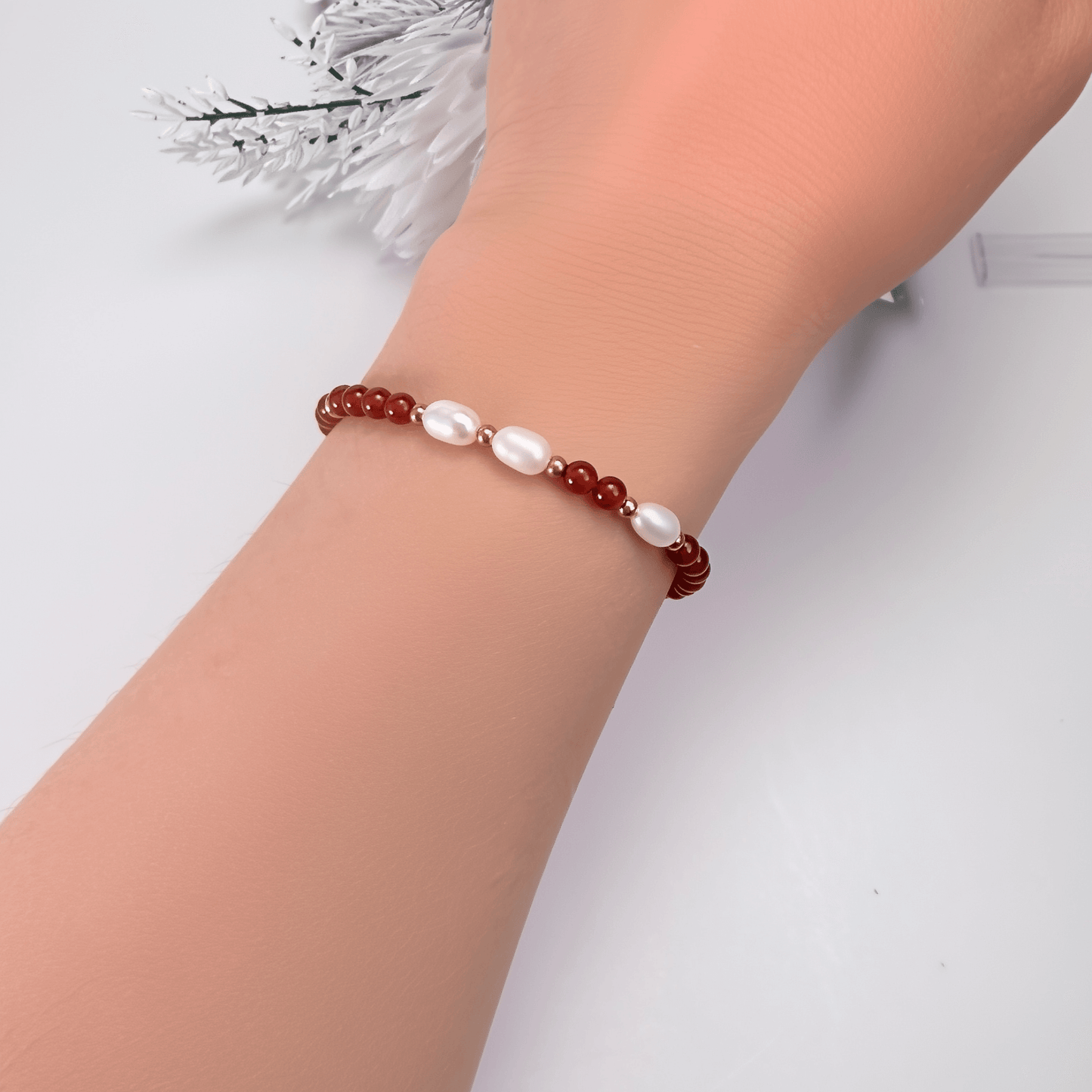 Handmade bracelet with red agate beads and freshwater pearl accents, finished with gold or silver findings.