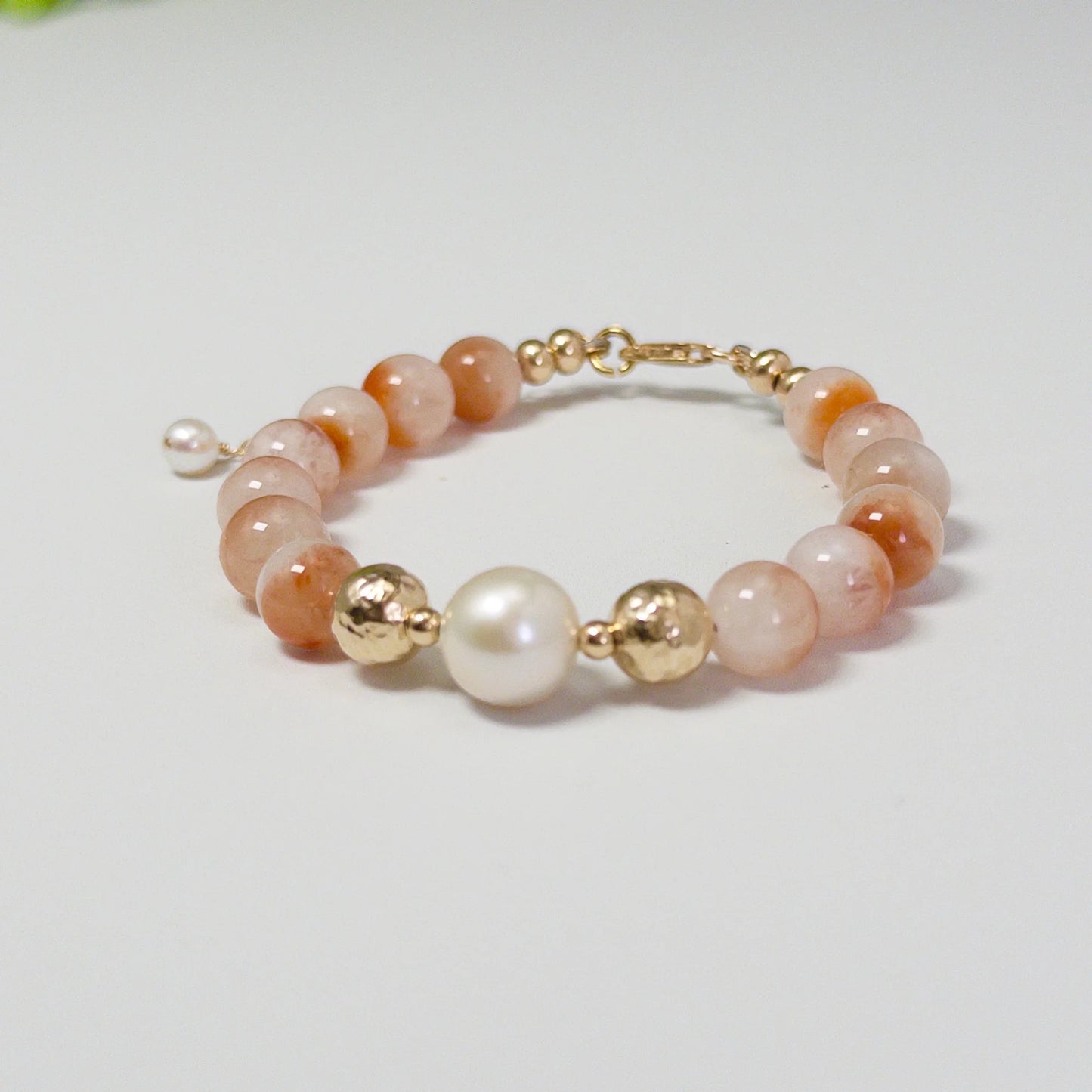 A 14k gold filled beaded bracelet featuring red rabbit hair quartz and premium freshwater pearl with stamped initial disc - MXW Jewellery