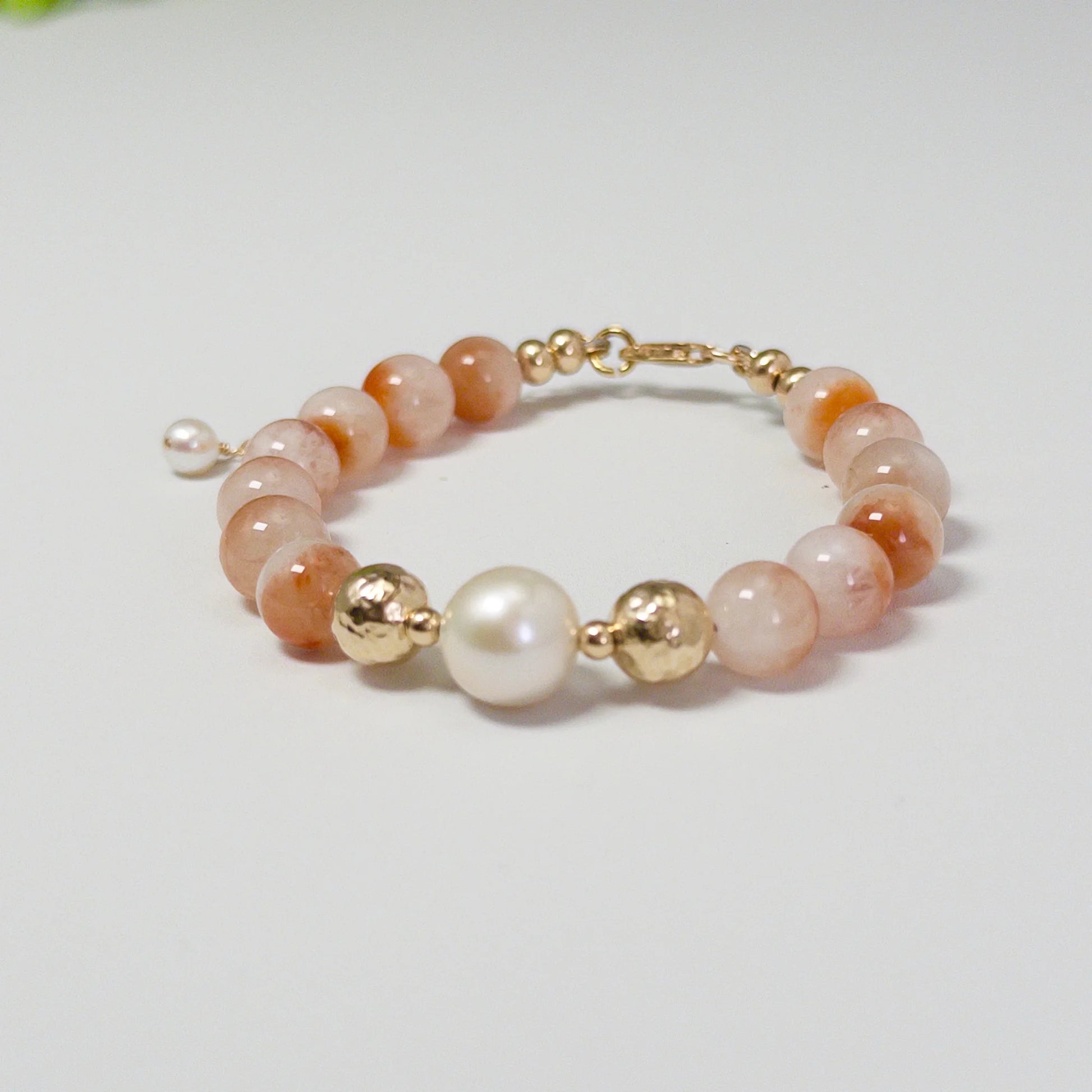 A 14k gold filled beaded bracelet featuring red rabbit hair quartz and premium freshwater pearl with stamped initial disc - MXW Jewellery