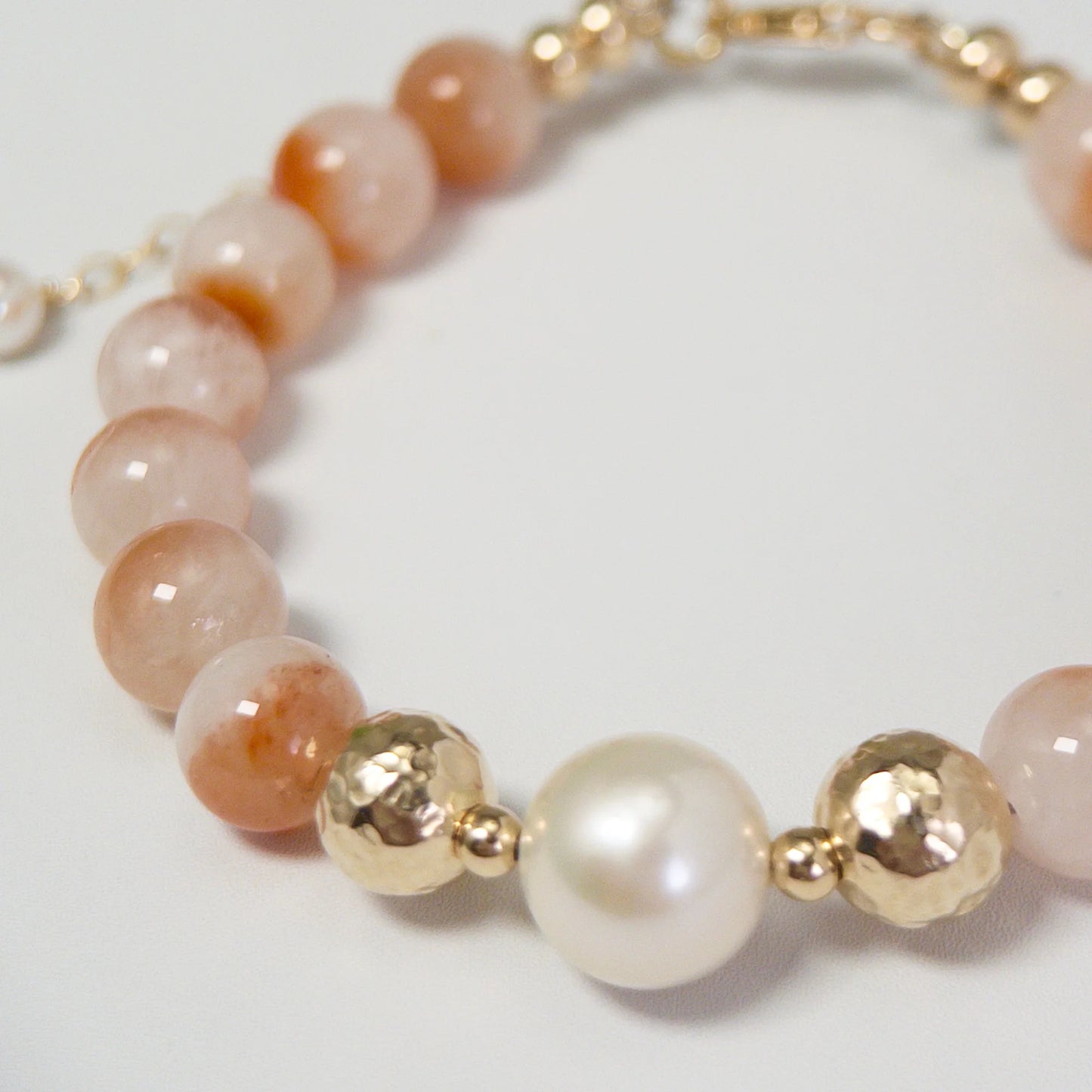 A 14k gold filled beaded bracelet featuring red rabbit hair quartz and premium freshwater pearl with stamped initial disc - MXW Jewellery