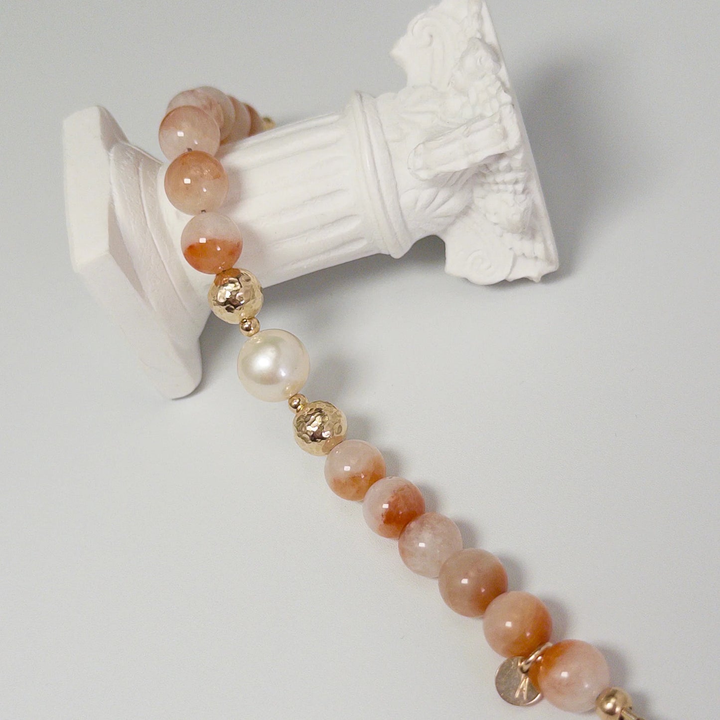 A 14k gold filled beaded bracelet featuring red rabbit hair quartz and premium freshwater pearl with stamped initial disc - MXW Jewellery