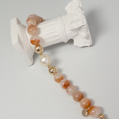 A 14k gold filled beaded bracelet featuring red rabbit hair quartz and premium freshwater pearl with stamped initial disc - MXW Jewellery