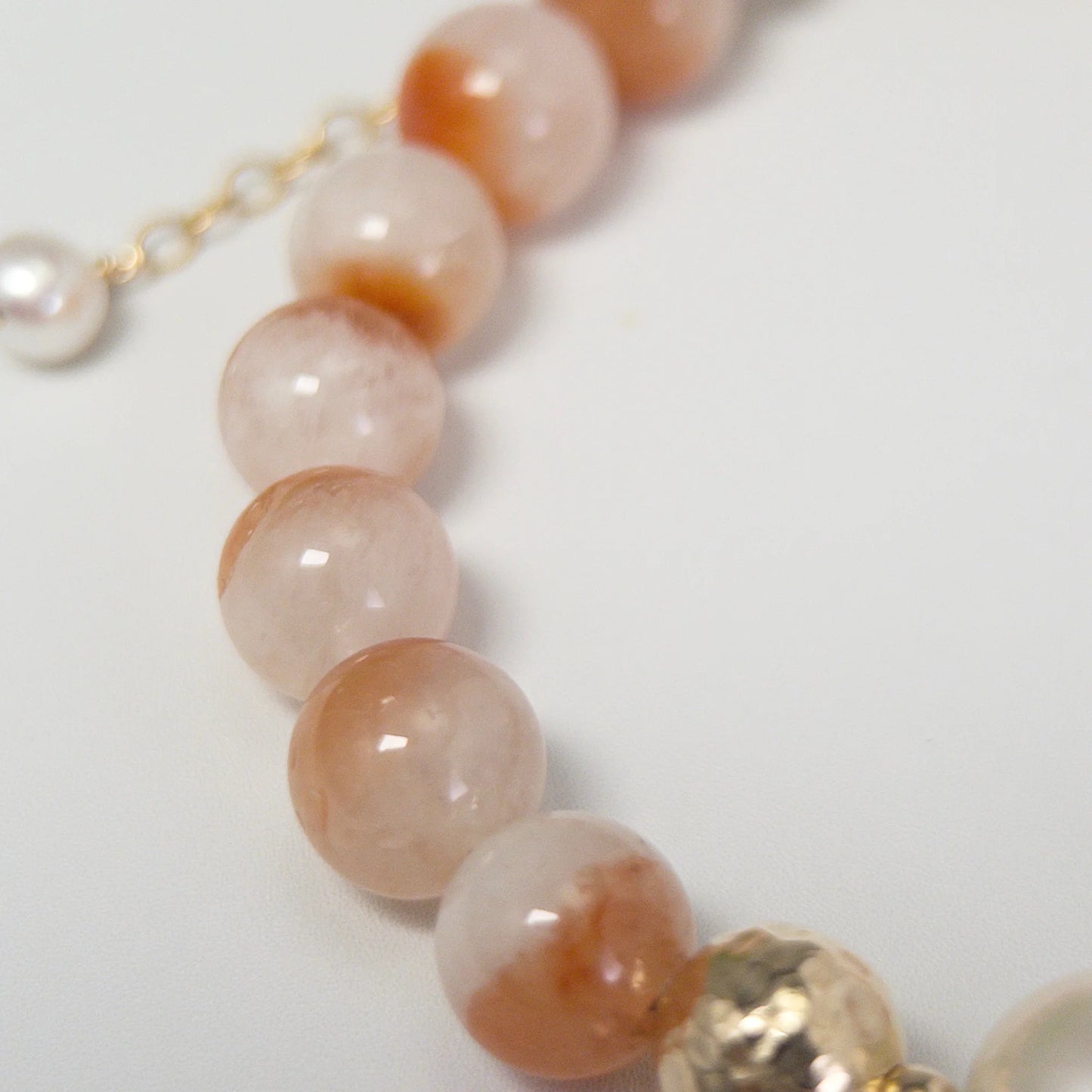 A 14k gold filled beaded bracelet featuring red rabbit hair quartz and premium freshwater pearl with stamped initial disc - MXW Jewellery