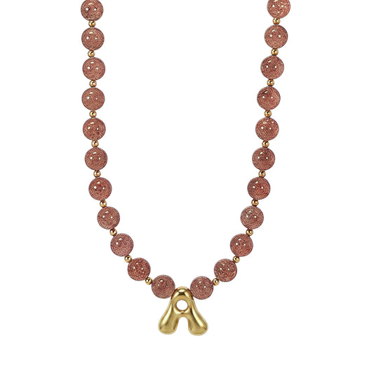 MXW Jewellery Red strawberry quartz beaded necklace with a gold bubble initial pendant.