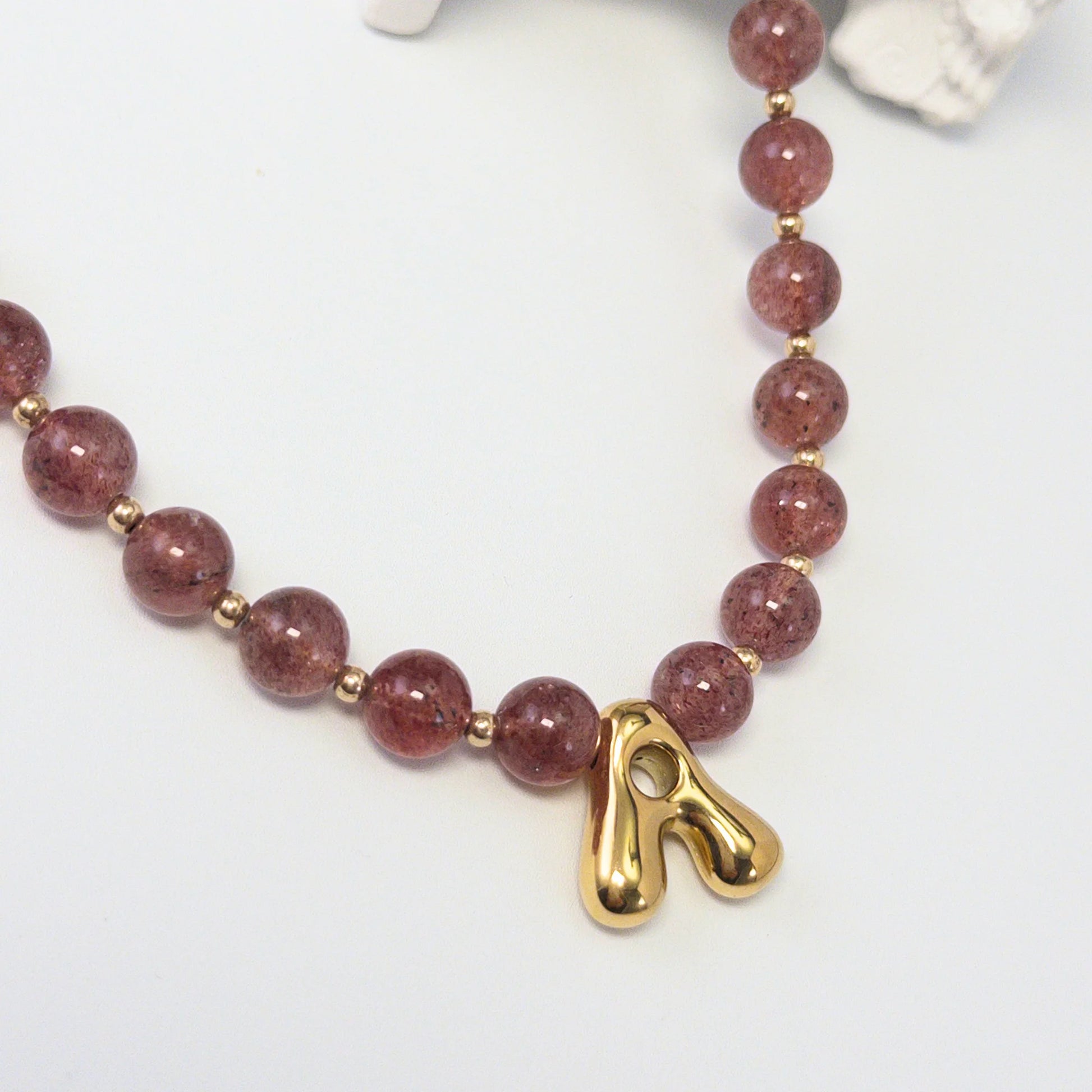 MXW Jewellery Red strawberry quartz beaded necklace with a gold bubble initial pendant.