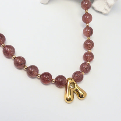 MXW Jewellery Red strawberry quartz beaded necklace with a gold bubble initial pendant.