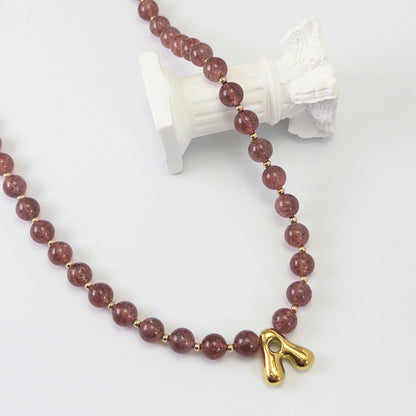 MXW Jewellery Red strawberry quartz beaded necklace with a gold bubble initial pendant.