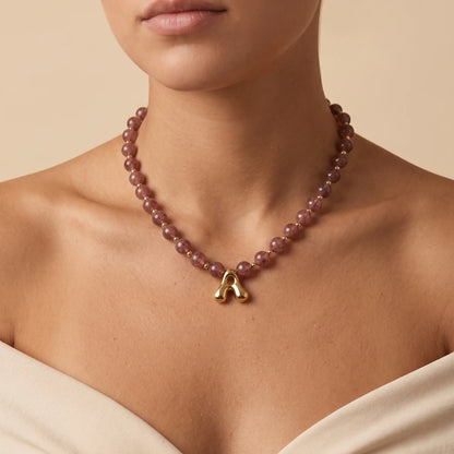 MXW Jewellery Red strawberry quartz beaded necklace with a gold bubble initial pendant.