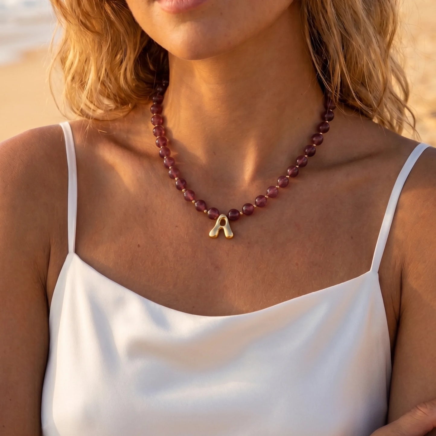 MXW Jewellery Red strawberry quartz beaded necklace with a gold bubble initial pendant.