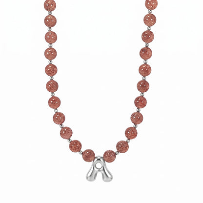 MXW Jewellery Red strawberry quartz beaded necklace with a silver bubble initial pendant.