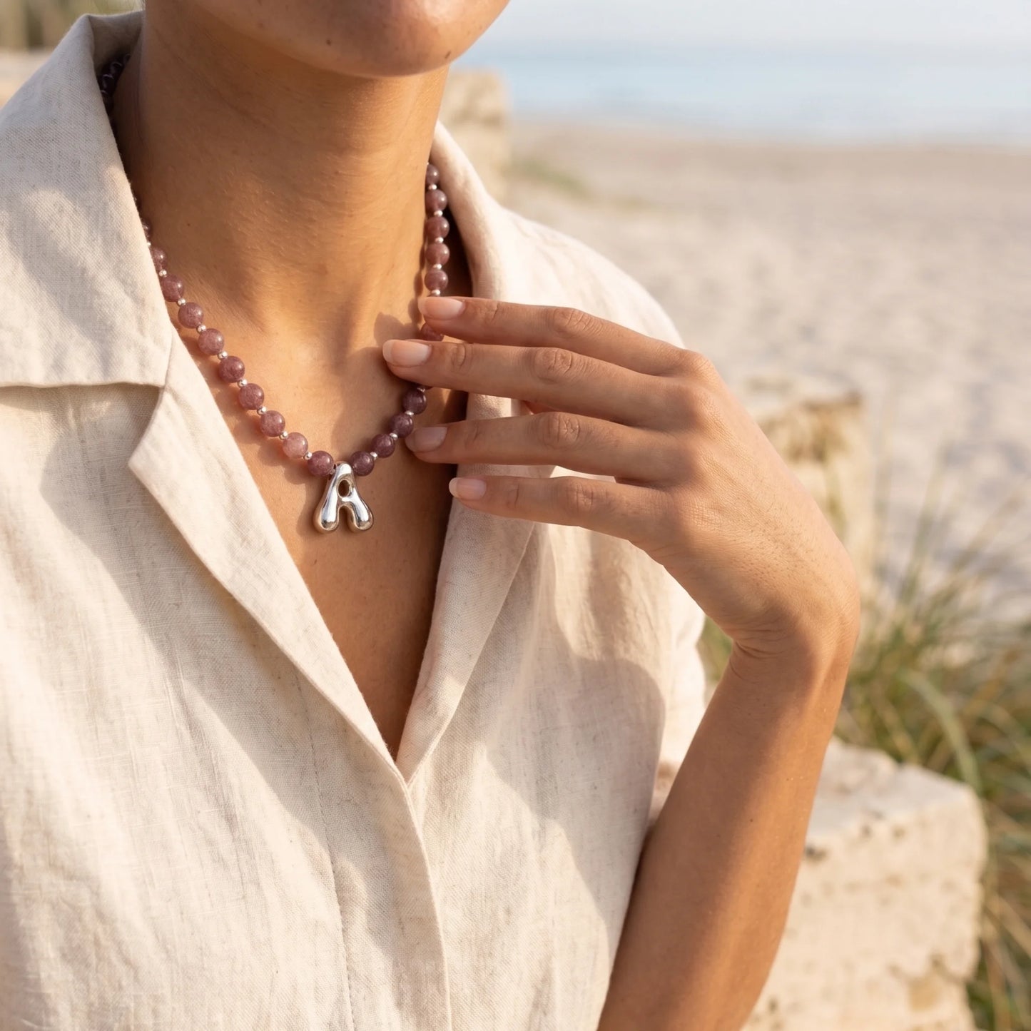 MXW Jewellery Red strawberry quartz beaded necklace with a silver bubble initial pendant.
