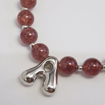 MXW Jewellery Red strawberry quartz beaded necklace with a silver bubble initial pendant.