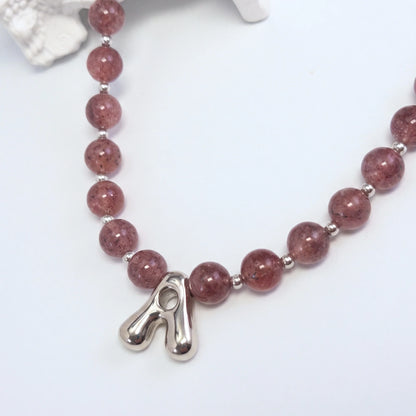 MXW Jewellery Red strawberry quartz beaded necklace with a silver bubble initial pendant.