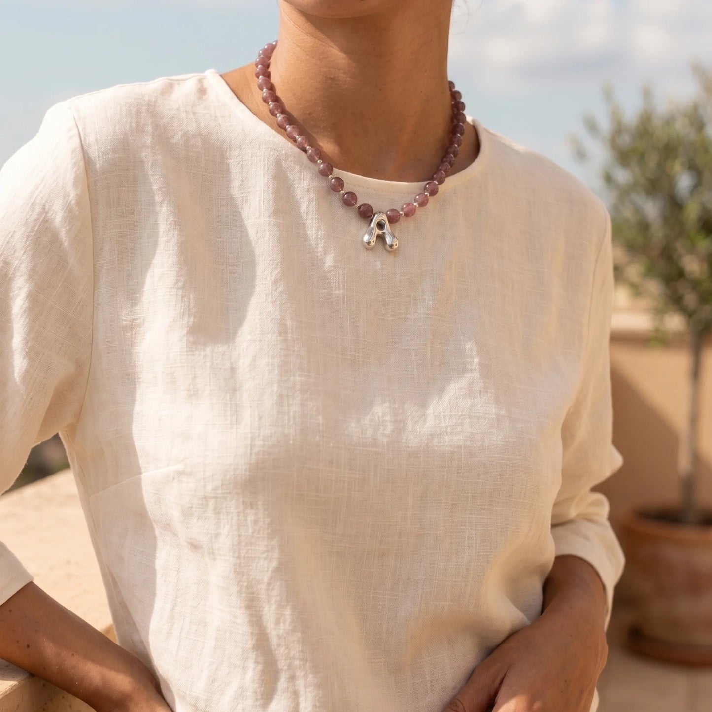 MXW Jewellery Red strawberry quartz beaded necklace with a silver bubble initial pendant.