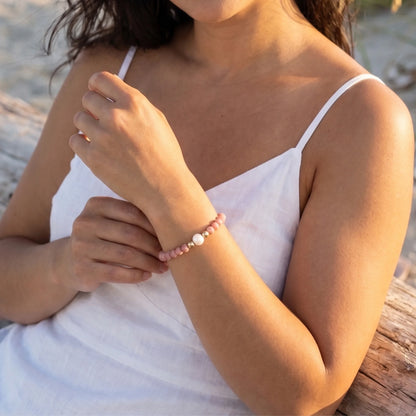Rhodochrosite, pearl and initial gold bracelet featuring natural pink gemstone beads, lustrous freshwater pearls and a personalised gold-filled stamped initial disc.