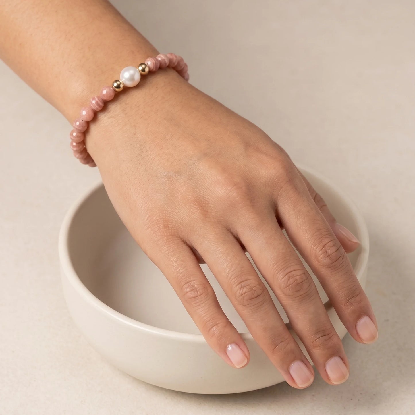 Rhodochrosite, pearl and initial gold bracelet featuring natural pink gemstone beads, lustrous freshwater pearls and a personalised gold-filled stamped initial disc.