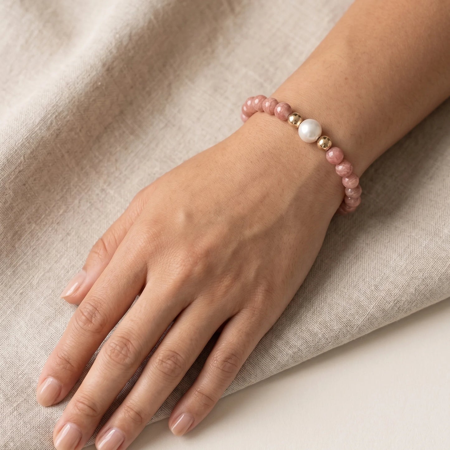 Rhodochrosite, pearl and initial gold bracelet featuring natural pink gemstone beads, lustrous freshwater pearls and a personalised gold-filled stamped initial disc.