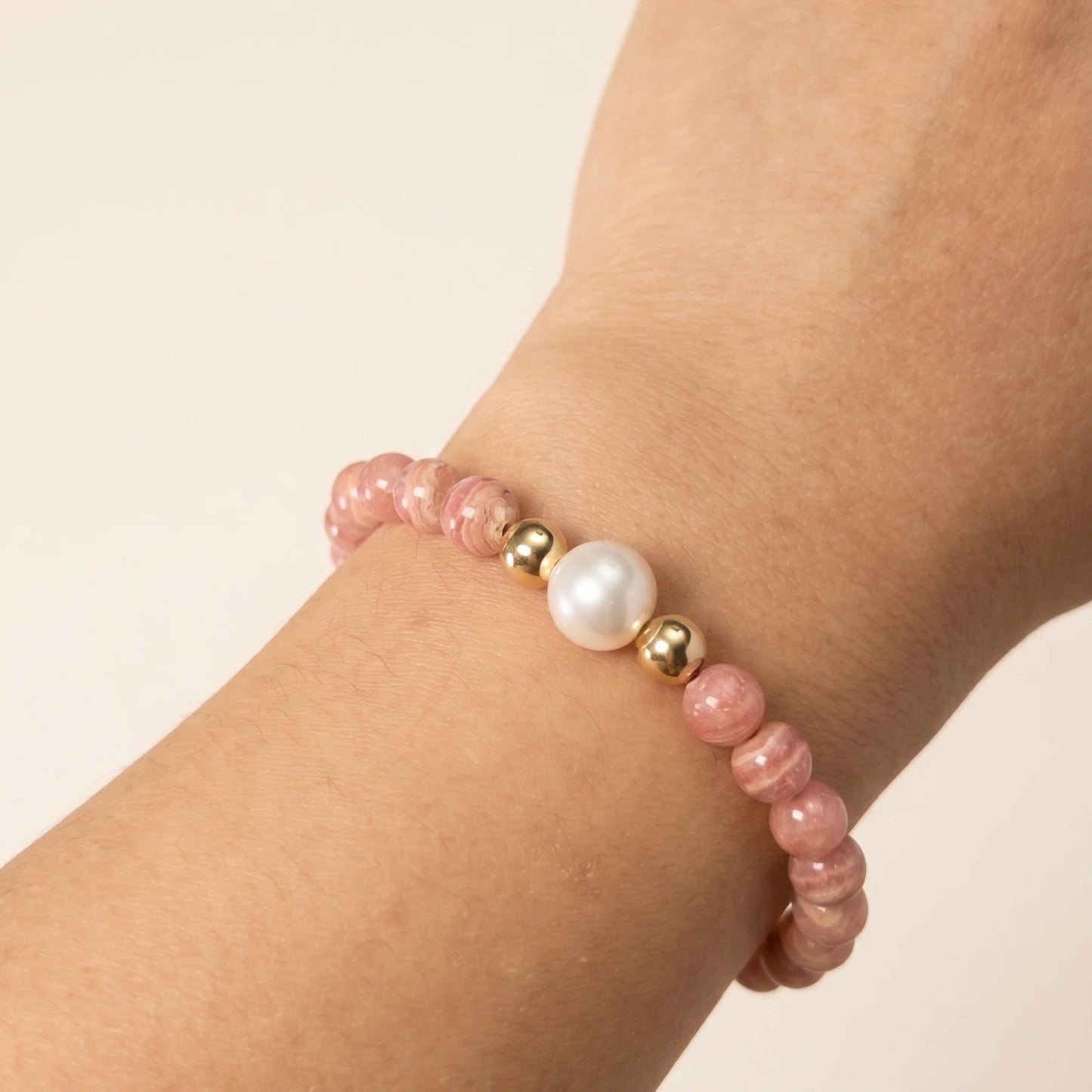 Rhodochrosite, pearl and initial gold bracelet featuring natural pink gemstone beads, lustrous freshwater pearls and a personalised gold-filled stamped initial disc.
