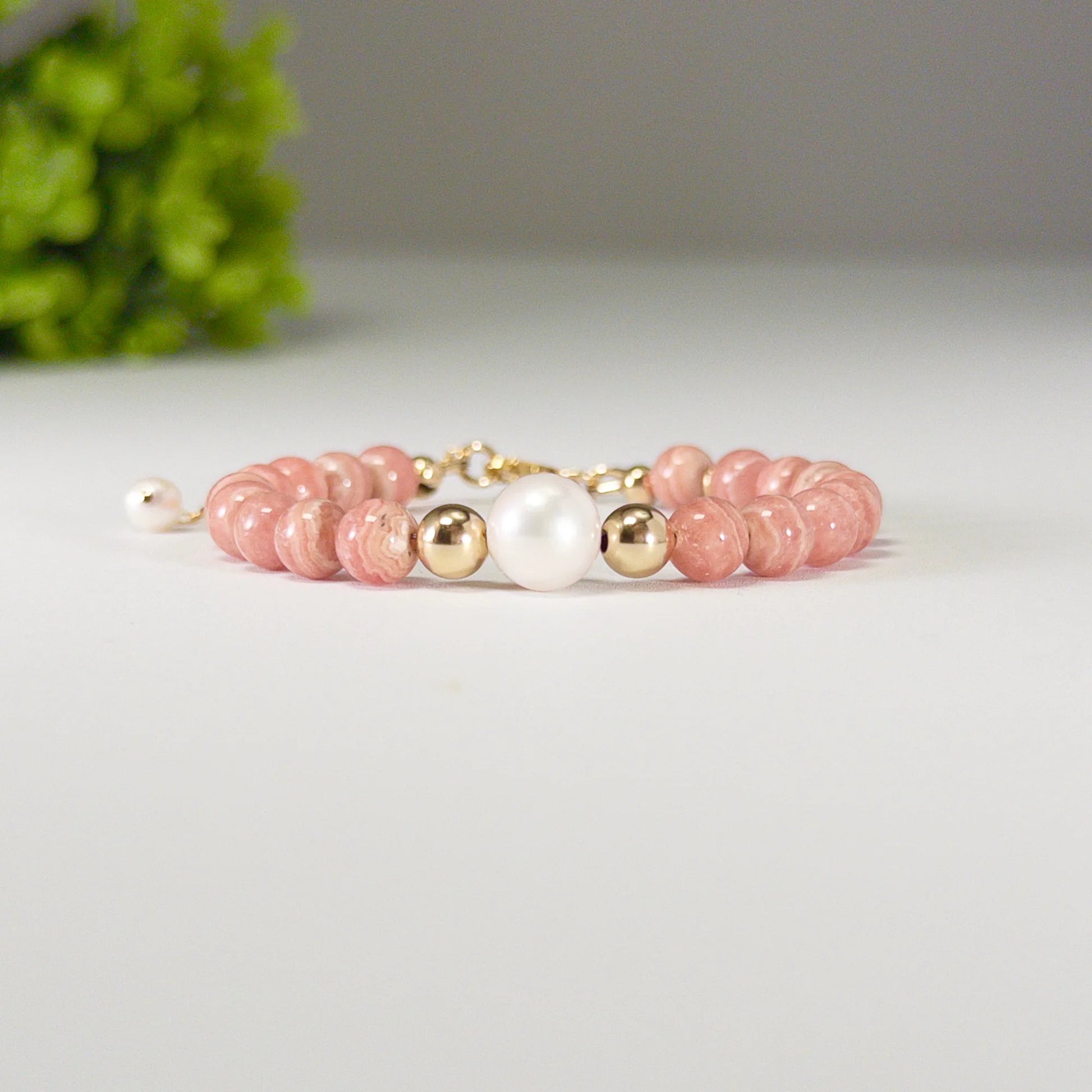 Rhodochrosite, pearl and initial gold bracelet featuring natural pink gemstone beads, lustrous freshwater pearls and a personalised gold-filled stamped initial disc.