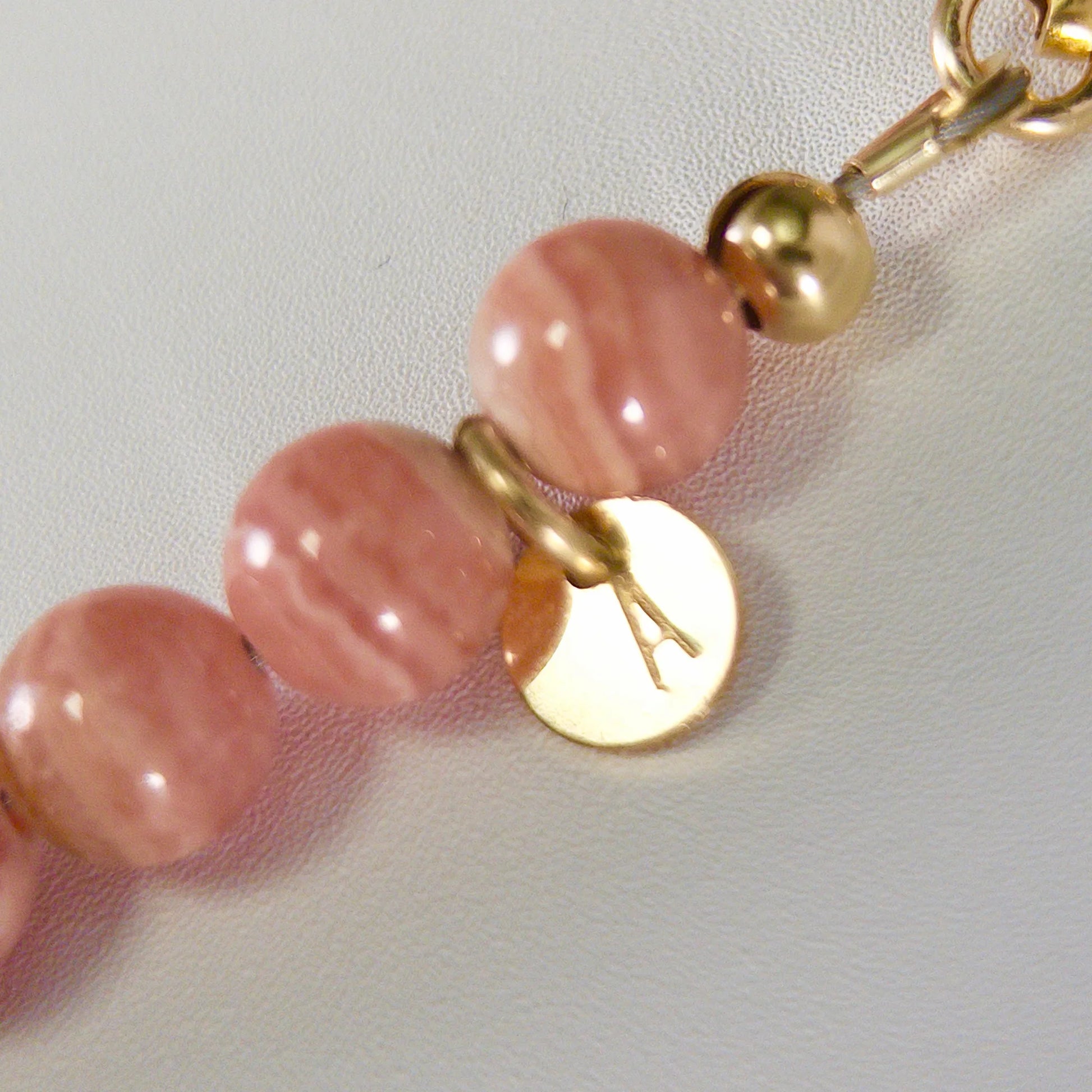 Rhodochrosite, pearl and initial gold bracelet featuring natural pink gemstone beads, lustrous freshwater pearls and a personalised gold-filled stamped initial disc.