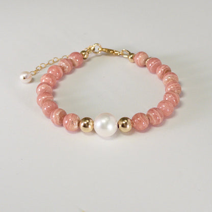 Rhodochrosite, pearl and initial gold bracelet featuring natural pink gemstone beads, lustrous freshwater pearls and a personalised gold-filled stamped initial disc.