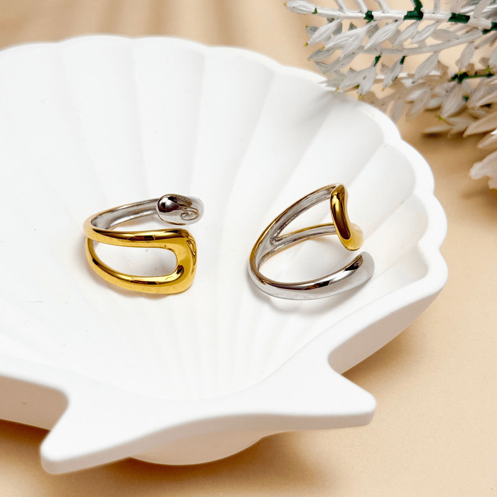 Sculpted Arc Ring in gold and silver, featuring a curved open-band design with smooth, reflective finish. Waterproof and hypoallergenic, worn as a modern statement ring.