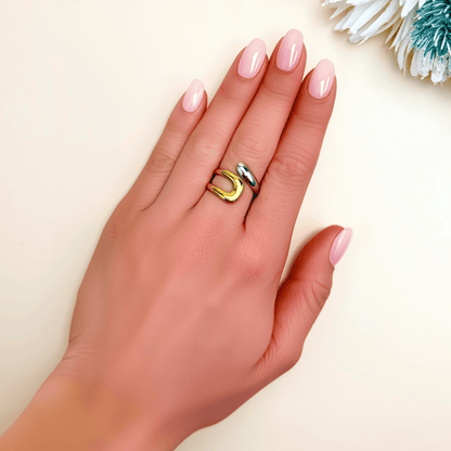 Sculpted Arc Ring in gold and silver, featuring a curved open-band design with smooth, reflective finish. Waterproof and hypoallergenic, worn as a modern statement ring.