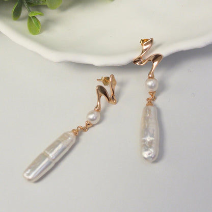 MXW gold vermeil drop earrings with a sculpted wave stud, a round freshwater pearl and a long baroque pearl drop.