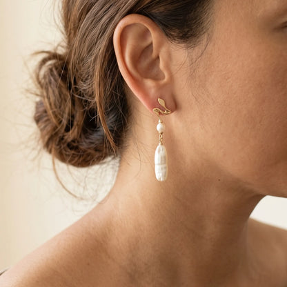 MXW gold vermeil drop earrings with a sculpted wave stud, a round freshwater pearl and a long baroque pearl drop.