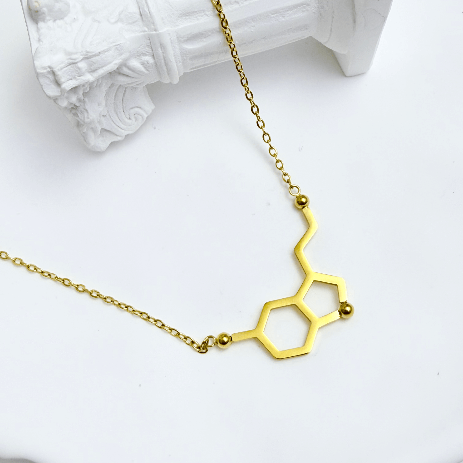 Gold serotonin molecule necklace on a fine chain, minimal jewellery