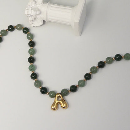 14K gold filled initial necklace with alternating nephrite jade and green aventurine beads and a bubble letter pendant