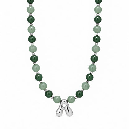 sterling silver necklace with alternating nephrite jade and green aventurine beads and a bubble letter pendant.