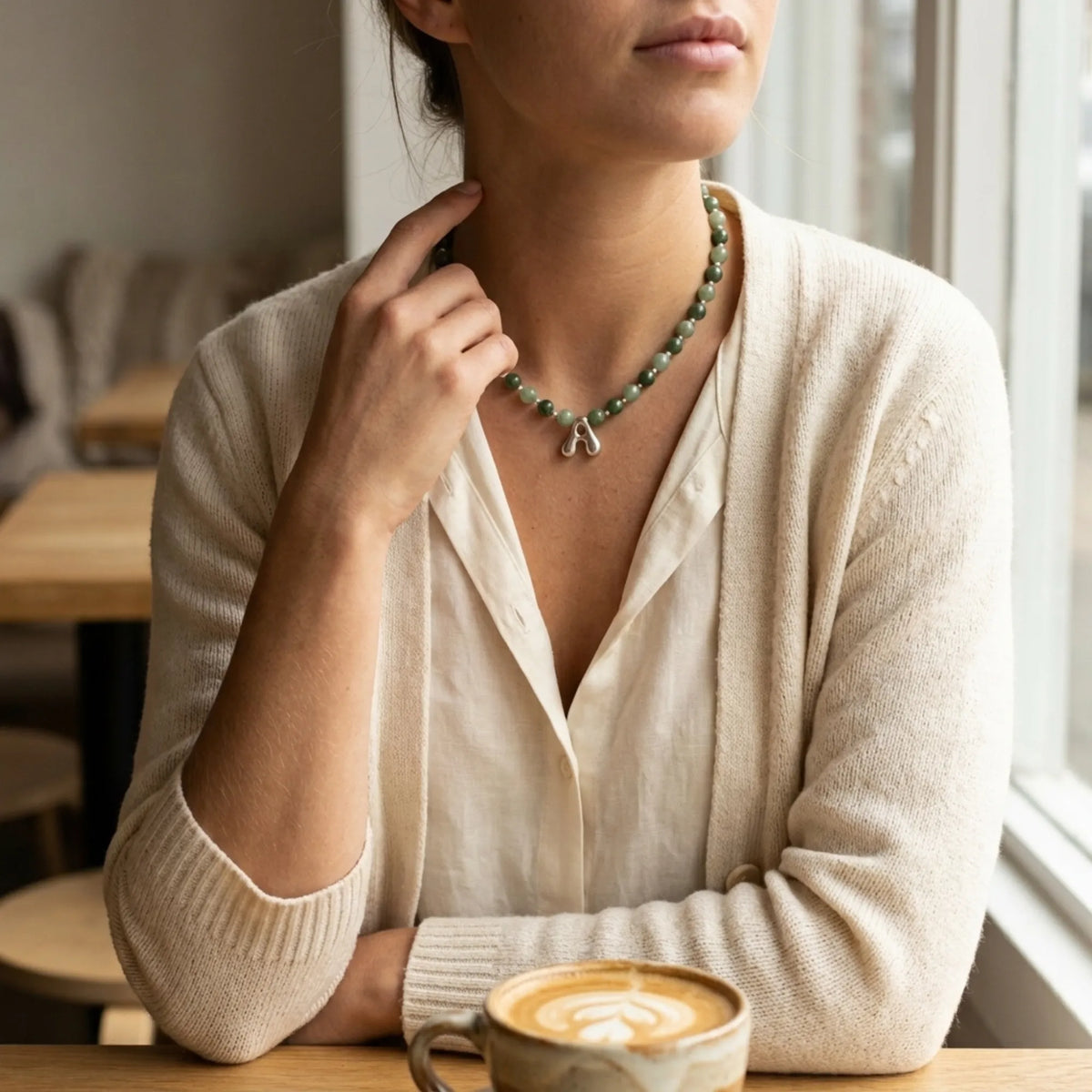 sterling silver necklace with alternating nephrite jade and green aventurine beads and a bubble letter pendant.