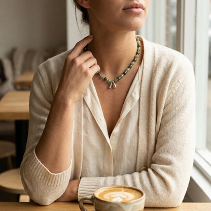 sterling silver necklace with alternating nephrite jade and green aventurine beads and a bubble letter pendant.