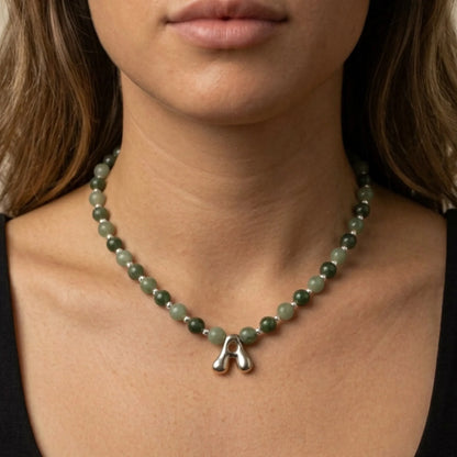 sterling silver necklace with alternating nephrite jade and green aventurine beads and a bubble letter pendant.