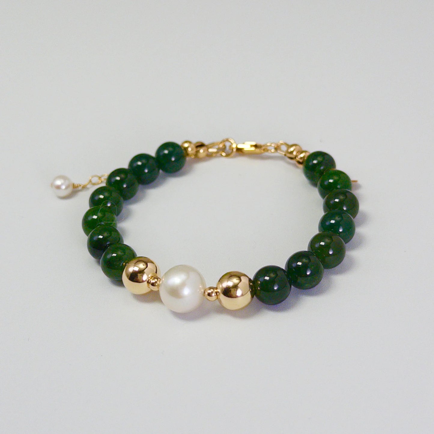 Siberian nephrite jade, pearl and initial bracelet featuring deep green gemstone beads, lustrous freshwater pearls and a personalised stamped 14K gold-filled initial disc.