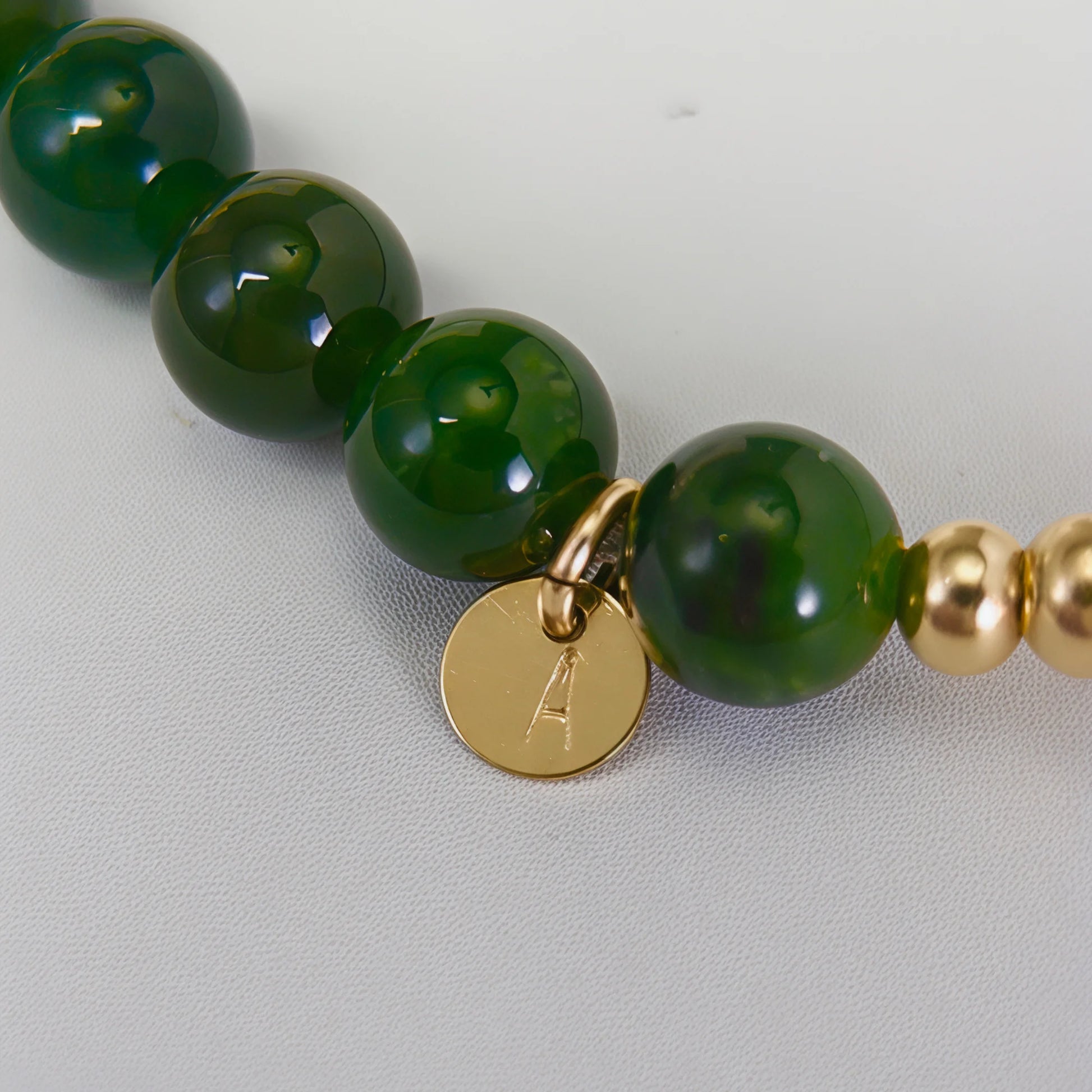 Siberian nephrite jade, pearl and initial bracelet featuring deep green gemstone beads, lustrous freshwater pearls and a personalised stamped 14K gold-filled initial disc.
