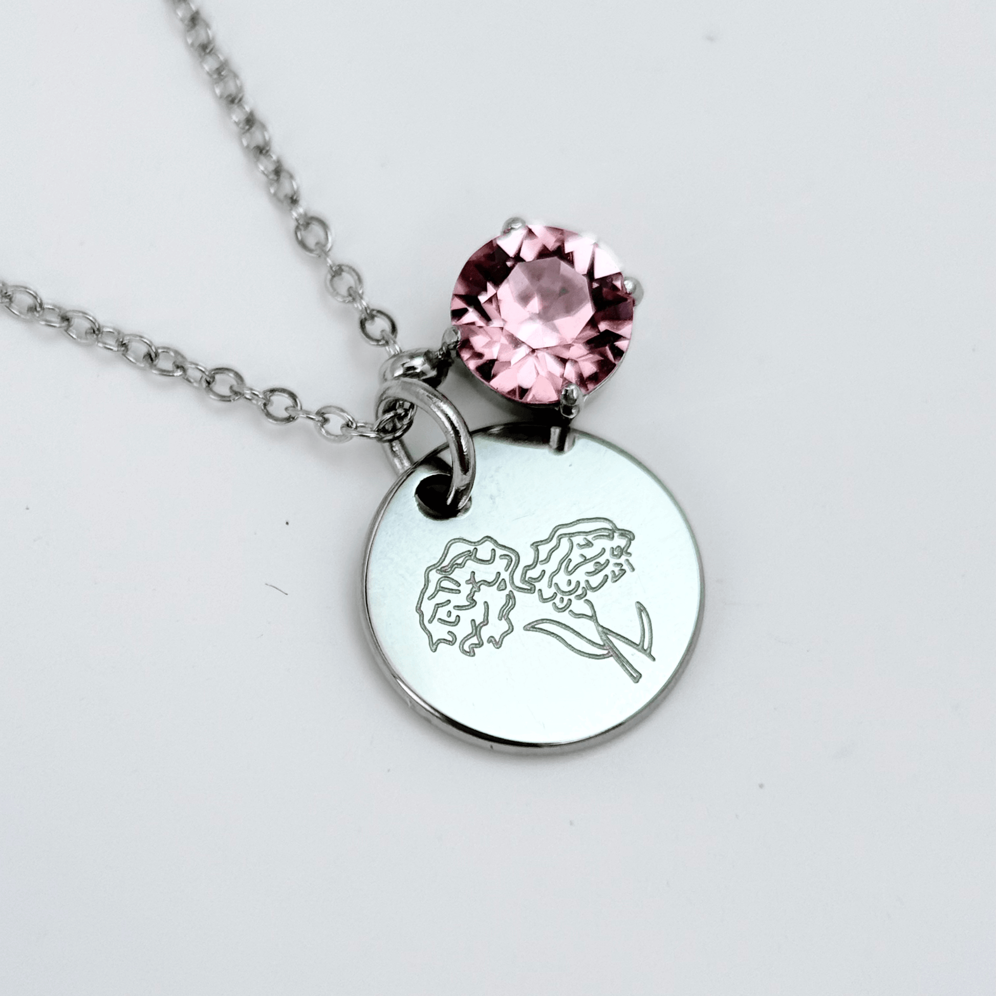 silver birth month necklace with blue crystal and engraved flower pendant