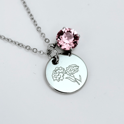 silver birth month necklace with blue crystal and engraved flower pendant